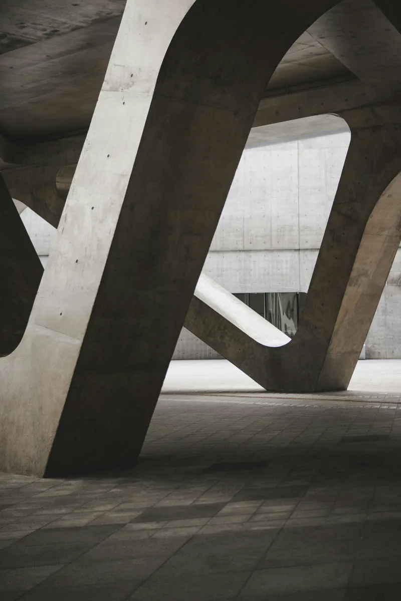 Sloping concrete columns and walls inside a large building